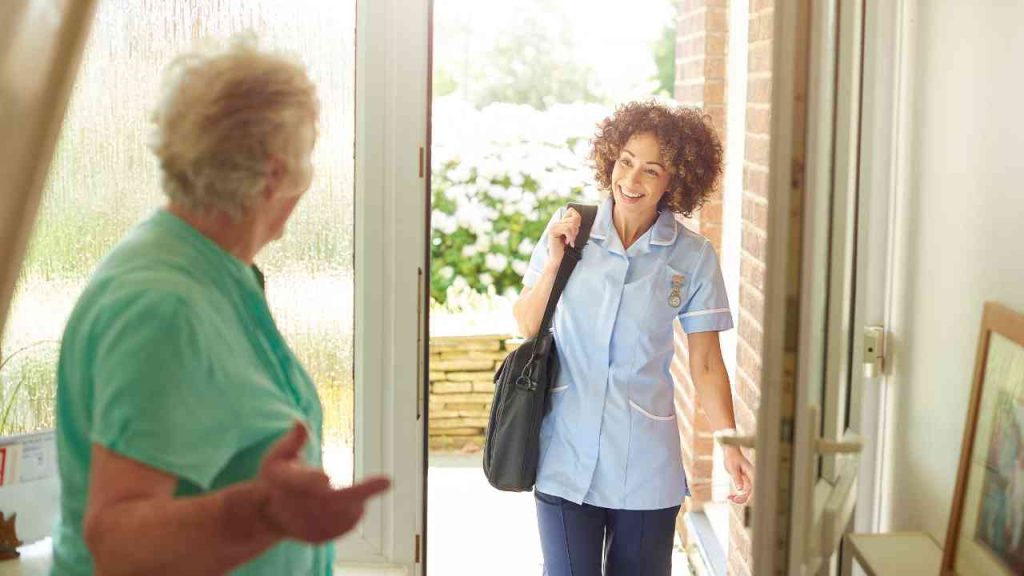 Home health aide providing respite care to a senior.
