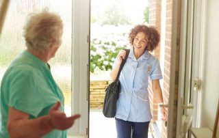Home health aide providing respite care to a senior.