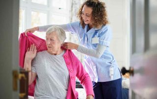 Caregiver helping Senior in a Continuing Care Retirement Community (CCRC).