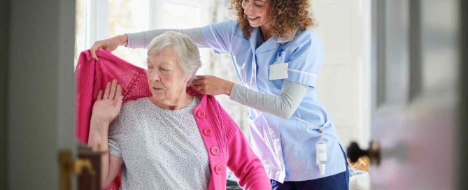 Caregiver helping Senior in a Continuing Care Retirement Community (CCRC).