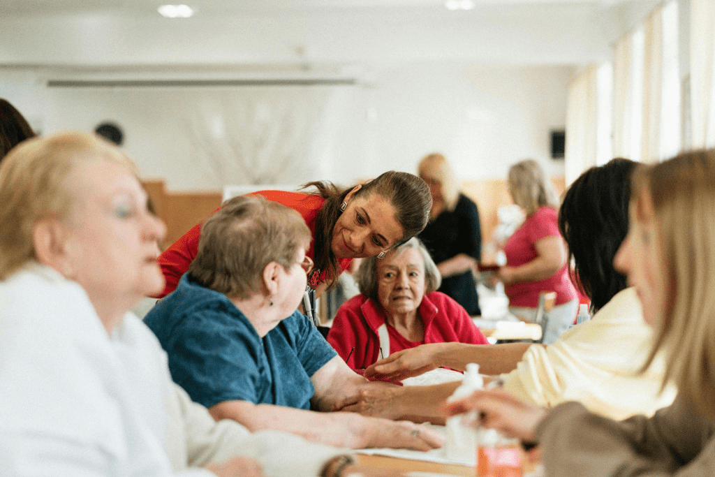 A woman talking to a group of senior women.