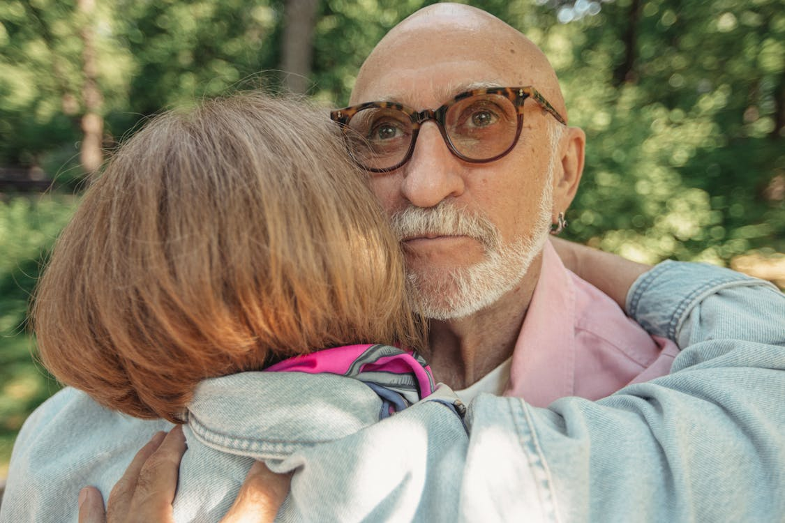  A person hugging someone elderly 