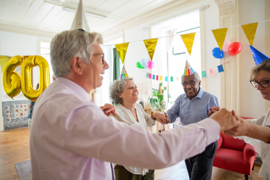 Elderly people having a party in an assisted living facility
