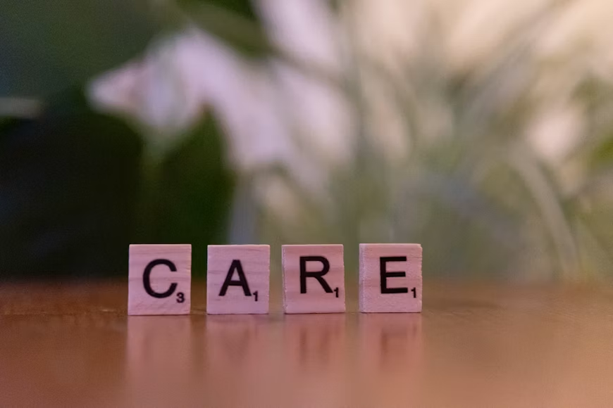 Scrabble tiles spelling ‘care’