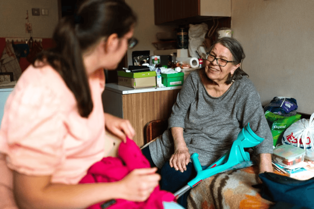 A caregiver talking to an elderly person