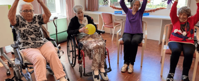 People holding balls and sitting in wheelchairs