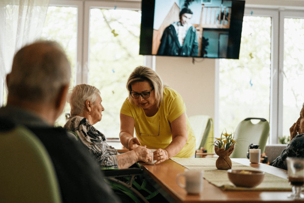 A caregiver taking care of elderly people in a facility 