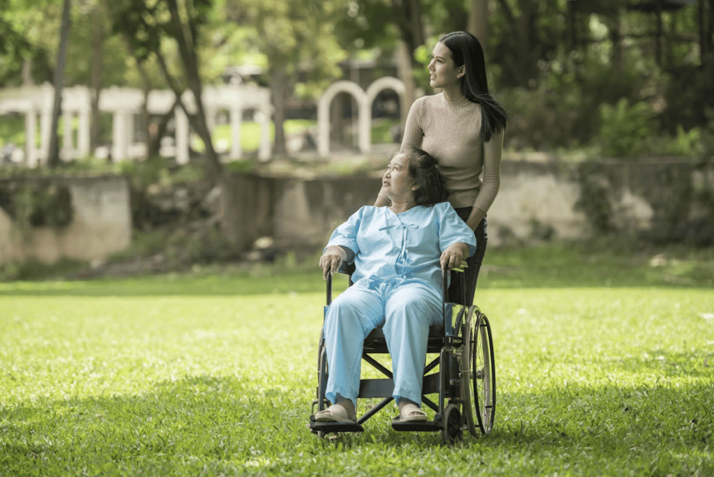 A person pushing another person's wheelchair
