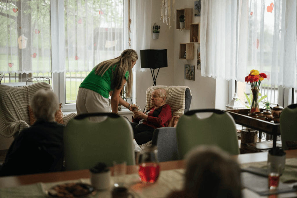 A caregiver helping an elderly person in a nursing home