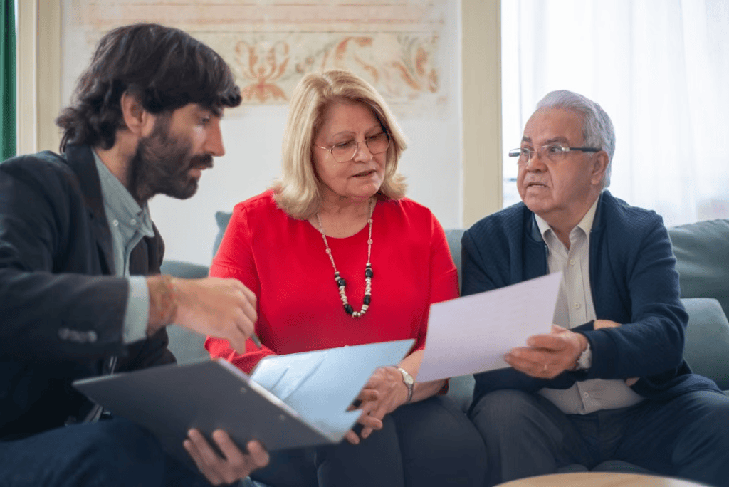 A senior couple speaking with a placement advisor indoors