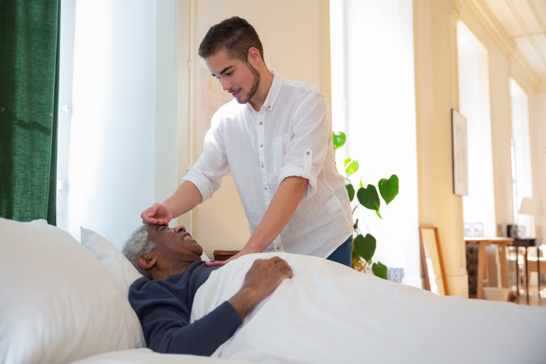 A caregiver checking on an elderly person