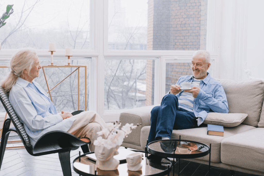 A senior couple relaxing and talking together at home